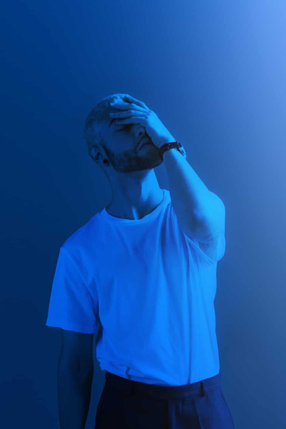 Depressed man covering his face