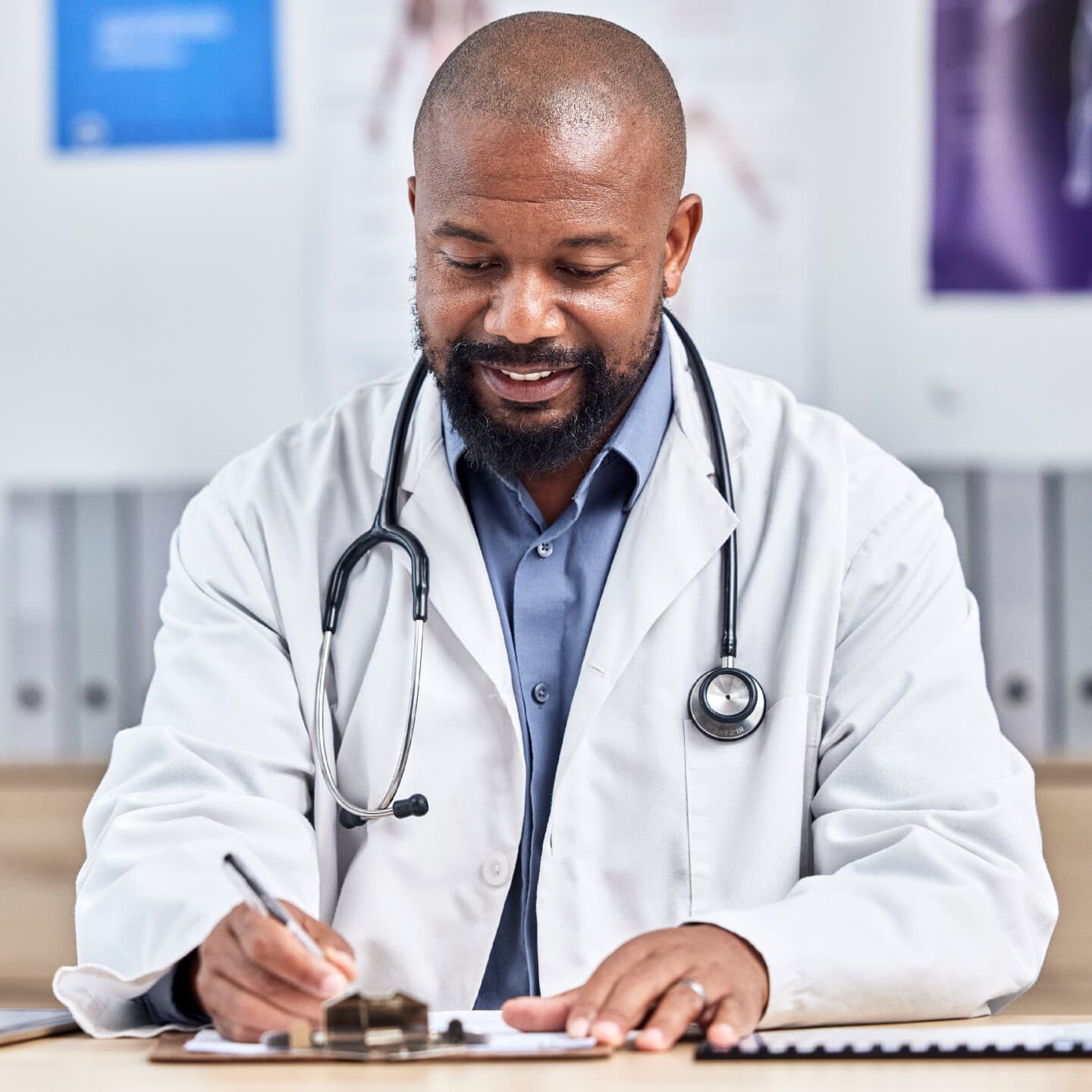 Doctor, medical office and black man writing notes, form or life insurance paperwork