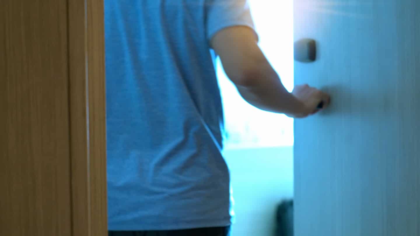 Motion blurred scene of hand man open the door into a room