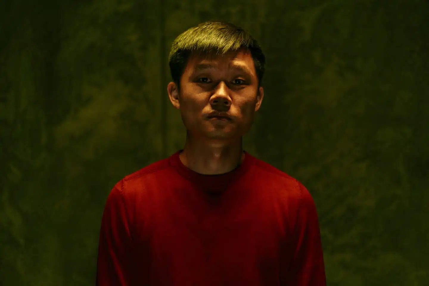 Sad and tired Asian man dark portrait