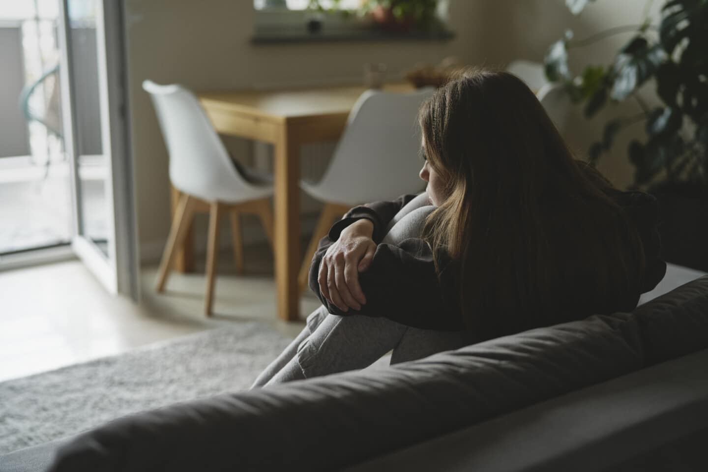 Sad woman sitting on the sofa with depression