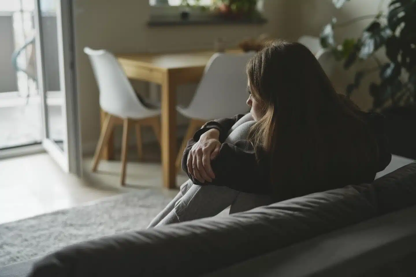 Sad woman sitting on the sofa with depression